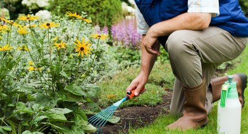 Operatives wearing PPE and using safe methods during garden maintenance